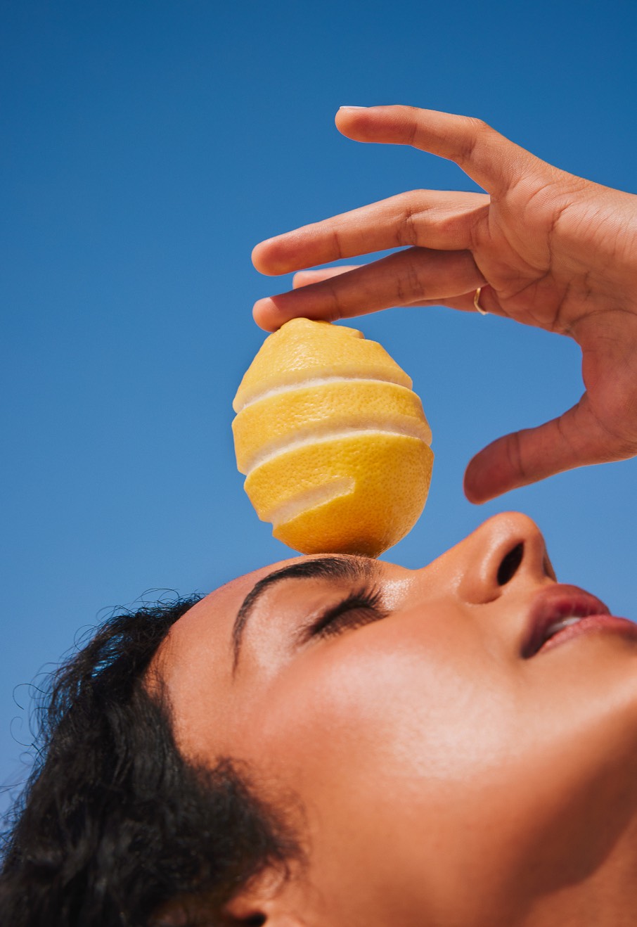 Woman with lemon on forehead