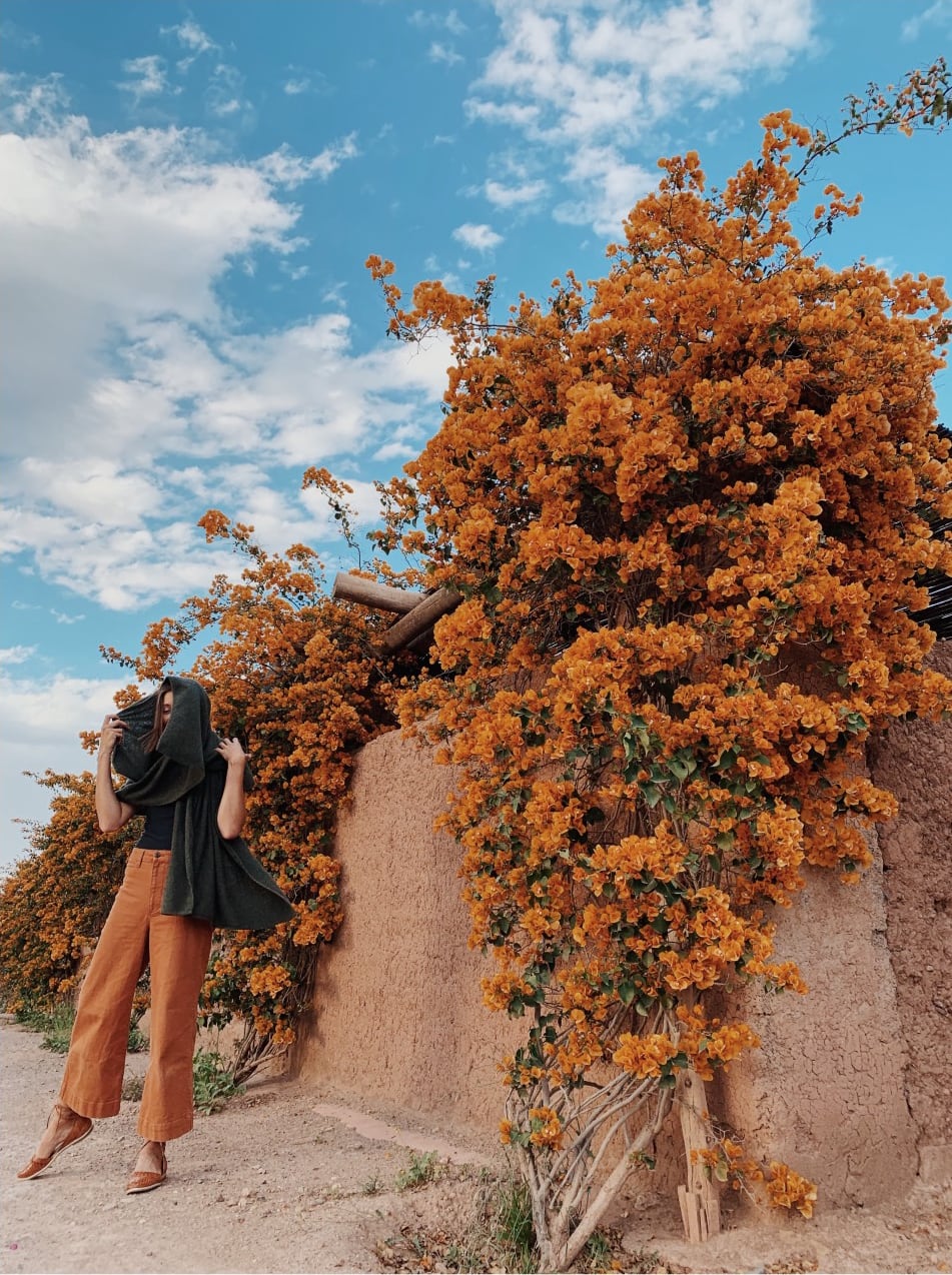 Kat Borchart in Morocco in front of orange plants
